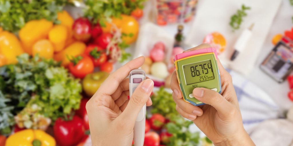 Person checking blood sugar with healthy foods in background.