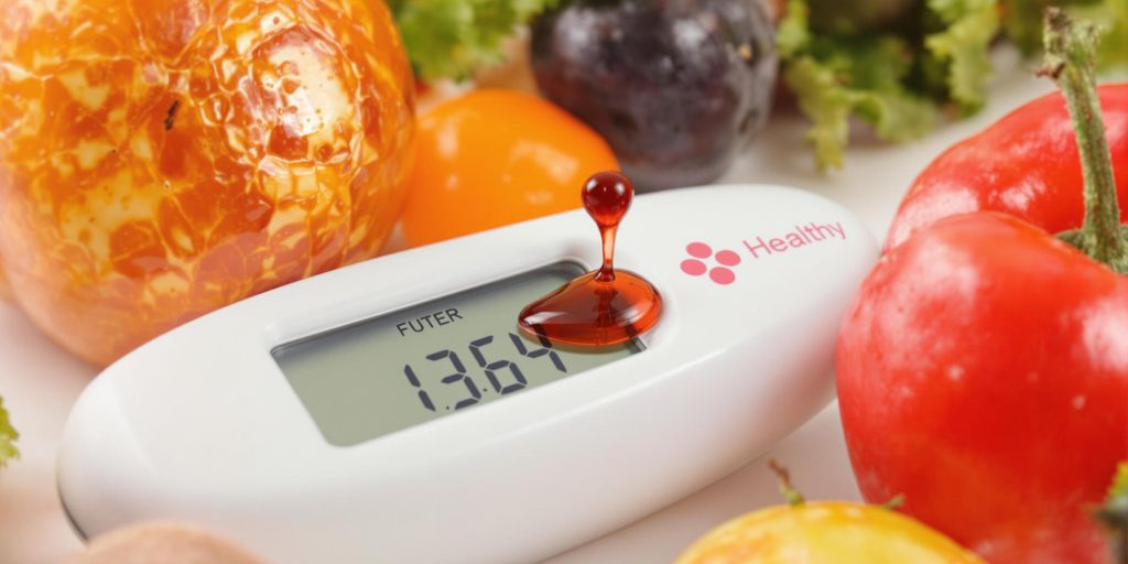 Blood glucose meter with fruits and vegetables around it.